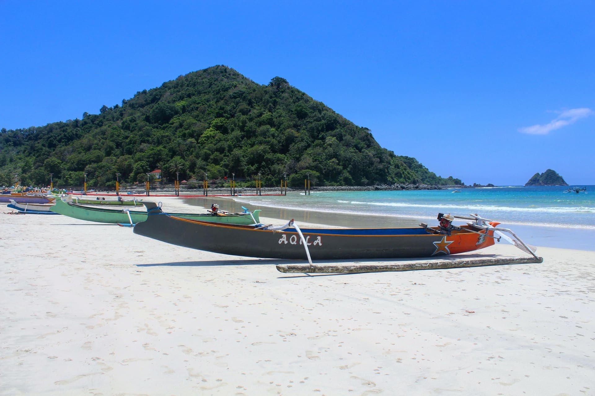 Traditional outrigger fishing boats on the white sand of Selong Belanak beach